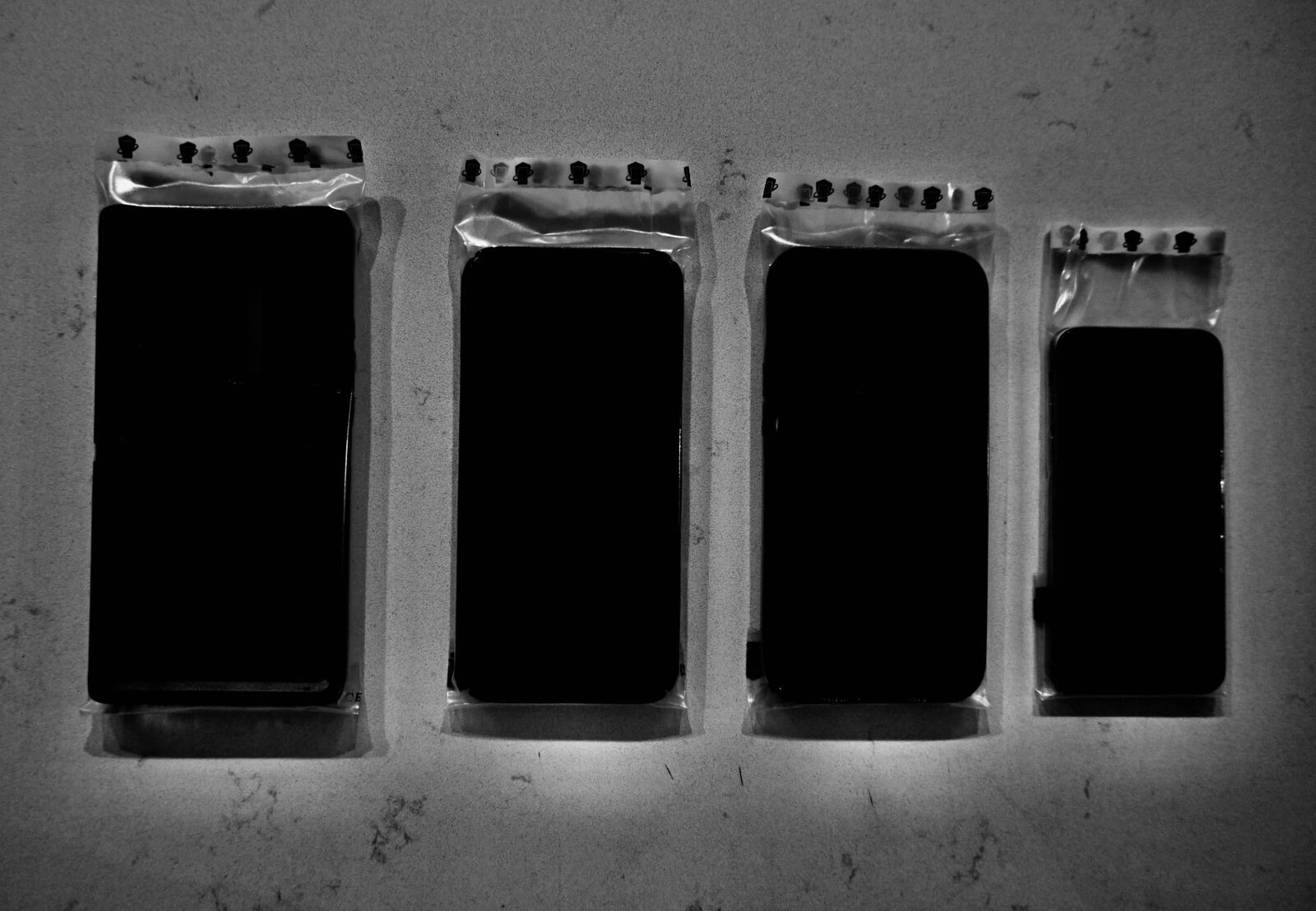 Four phones of different sizes, each in a WynnShield™ wrap