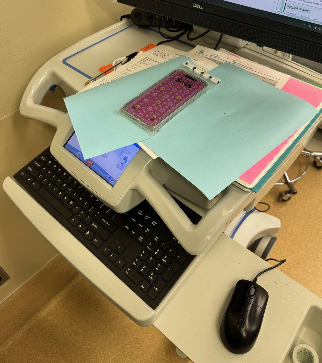 WynnShield™-wrapped phone resting on a hospital workstation cart