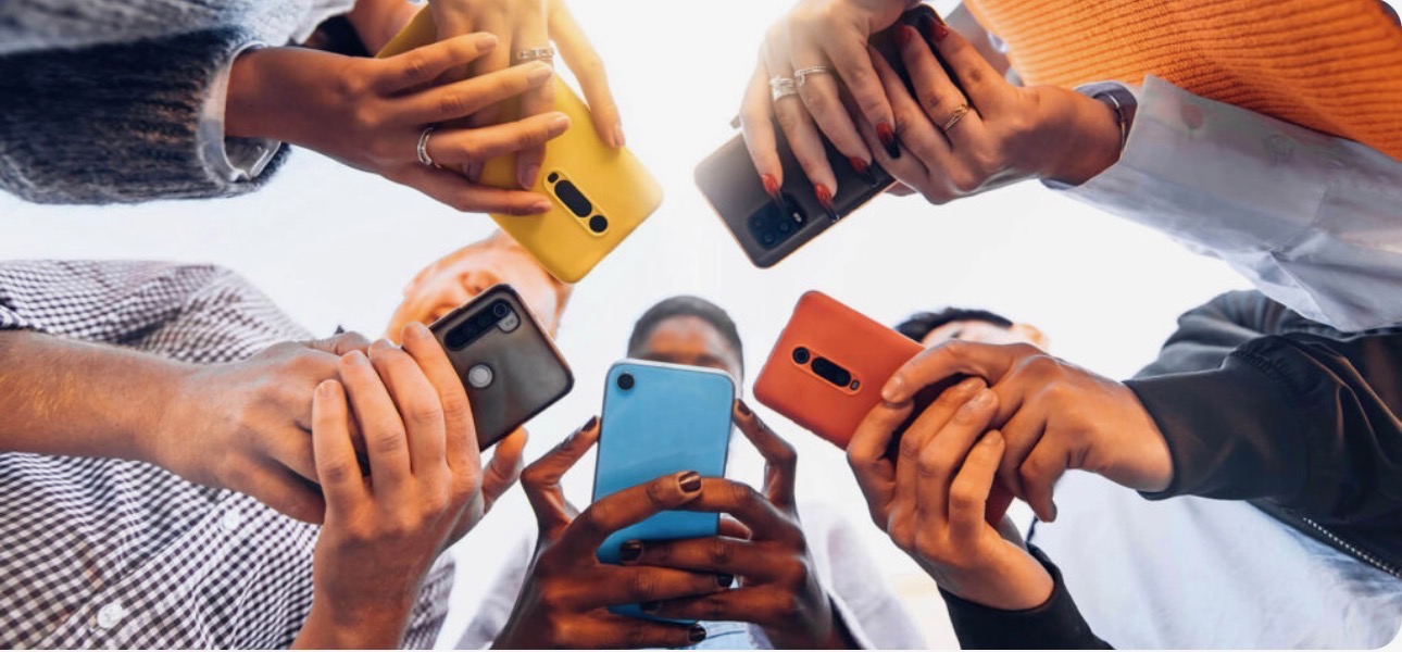 Group of people holding their phones together in a circle